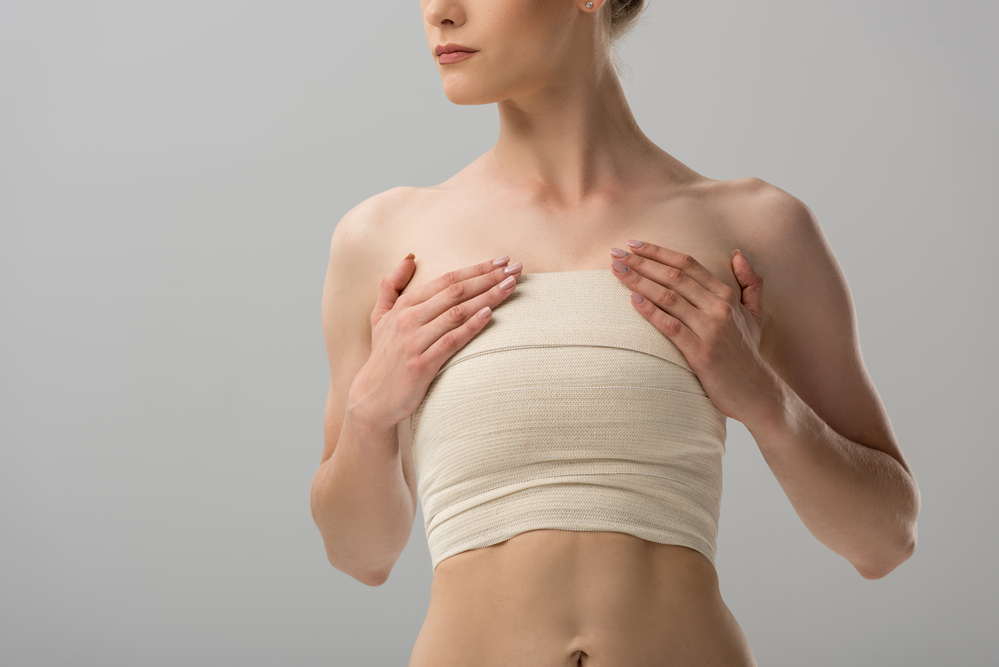 Woman with bandages covering breast